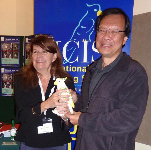 Liliane hands over the ICIS mascot and the Presidency to Vincent Chong