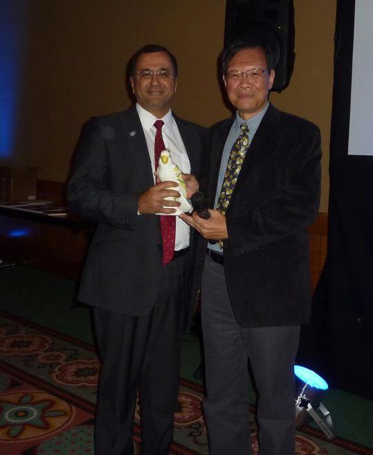 Handing over the parrot to incoming President, Dr. Anwar Padhani. 